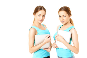 Two smiling women holding tablet computer