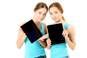 Fototapeta premium Two smiling women holding tablet computer