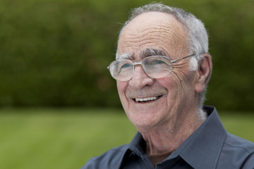 Senior man with glasses smiling