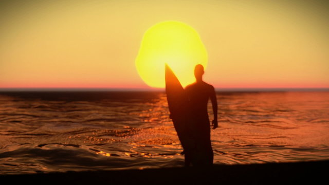 Silhouette of a surfer with his surfboard on the sunset