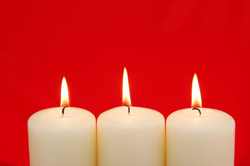 Holiday Candles with red background and copy space