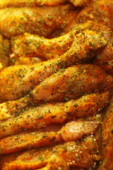 Closeup raw marinated chicken meat drumstick