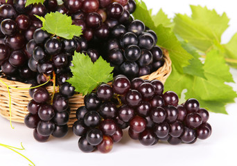 Grapes in basket with leaf on white background