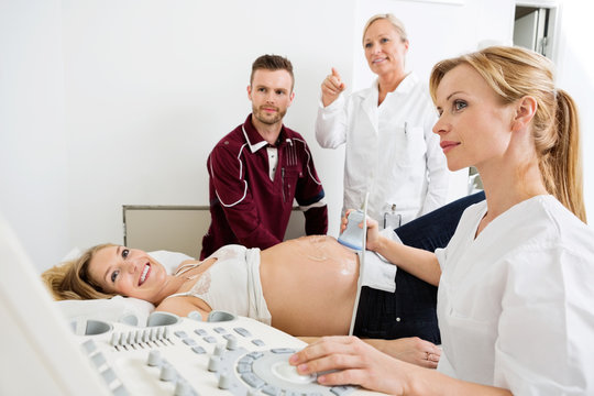 Couple And Doctors Looking At Ultrasound
