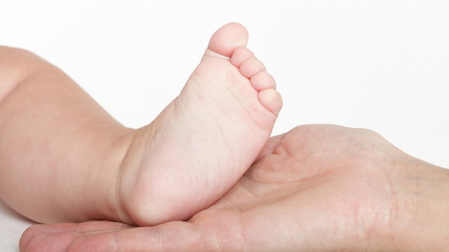 Baby foot in mother hands