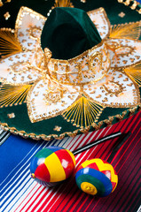 Multicolored mexican maracas, sombrero and poncho