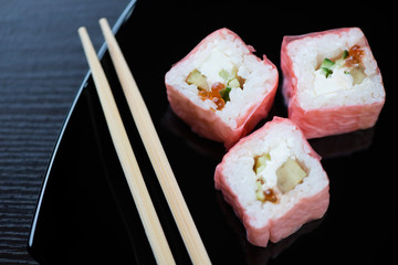 Sushi set and chopsticks on a black plate