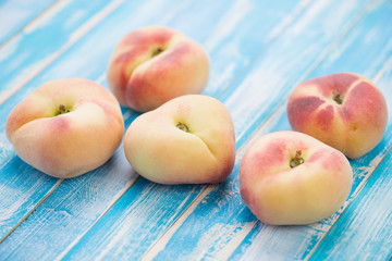 Chinese flat peaches on wooden boards