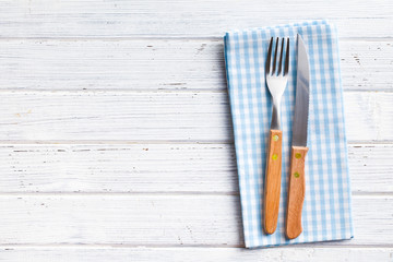 knife and fork on checkered napkin