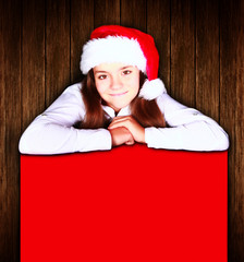 christmas girl holding banner over wooden background
