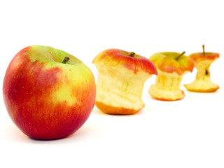 Apple and cores lying diagonally isolated on white background