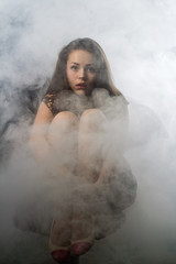 Portrait of the young girl in a smoke