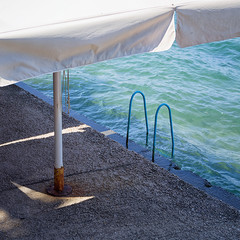 Umbrella, sea and ladder, in Nafplio, Greece