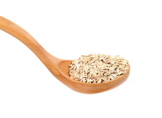 Oatmeal flakes into wooden spoon.