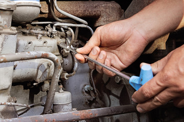 Engine service. Worker hands.