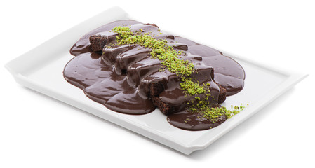 Pile of brownies with chocolate sauce isolated on white