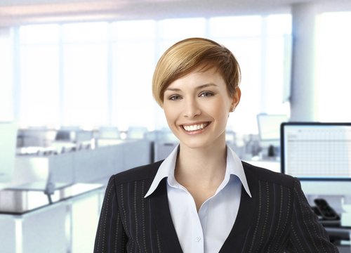 Happy businesswoman in corporate office