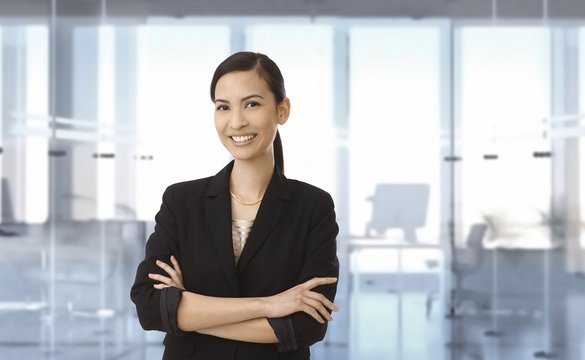Happy asian businesswoman at office