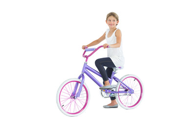 Fototapeta premium Cute young girl riding bike