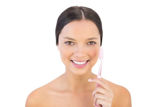 Smiling woman holding her teeth brush