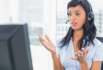 Confused operator looking at her computer
