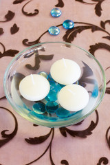 three lampion in a glass on a chocolate brown table