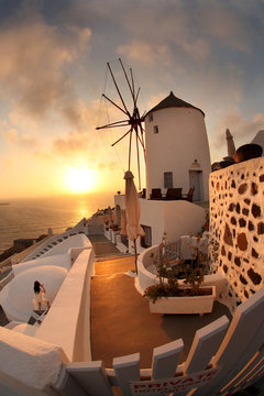 Fototapeta Windmill in Santorini against sunset, Greece