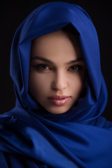 Naklejka premium Beauty in blue cloth. Portrait of beautiful young woman covered