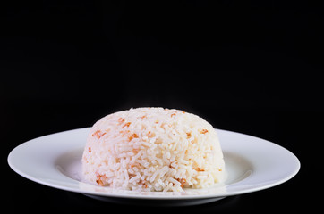 Rice in a dish on black background