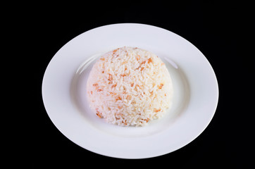 Rice in a dish on black background