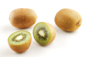 A few organic kiwi fruits shot against a white background
