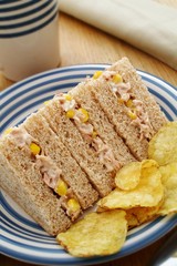 Fototapeta na wymiar Tuna and sweetcorn sandwich with potato chips