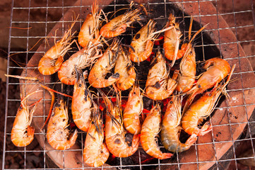 grilled prawns on flaming grill