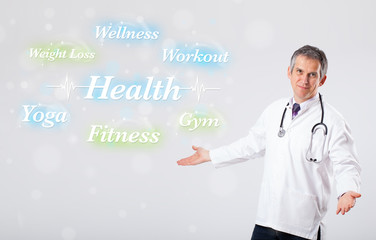Clinical doctor pointing to health and fitness collection of wor