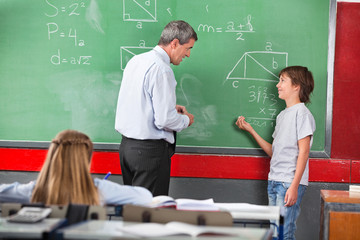 Schoolboy Asking Question To Teacher While Solving Mathematics