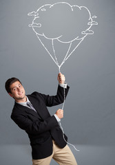 Handsome man holding cloud balloon drawing