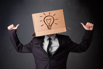 Businessman gesturing with a cardboard box on his head with ligh