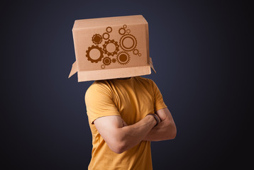 Young man gesturing with a cardboard box on his head with spur w
