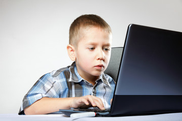 Computer addiction child with laptop notebook