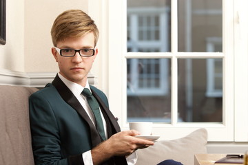 Young handsome stylish man in cafe with coffee