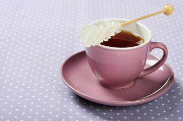 Tea in cup with candy sugar