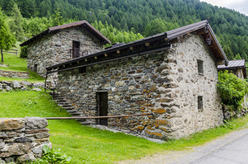 Obraz premium Stone shepherd's house in a peasant village in alpine meadows