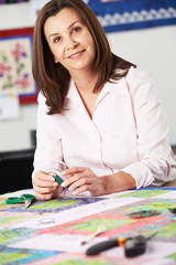 Portrait Of Woman Sewing Quilt