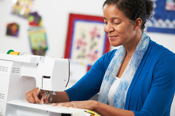 Woman Using Electric Sewing Machine