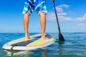 Man on Stand Up Paddle Board - obrazy, fototapety, plakaty