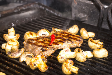 cooking steak and vegetables on the grill