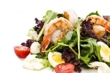 salad greens and shrimp on a white background in the restaurant