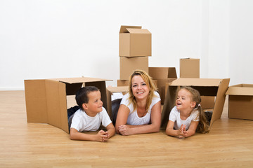 Happy woman and kids relaxing in their new home