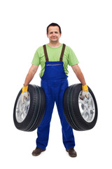 Fototapeta na wymiar Car mechanic with two tires