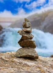Stigfossen waterfall and stones stack - Norway